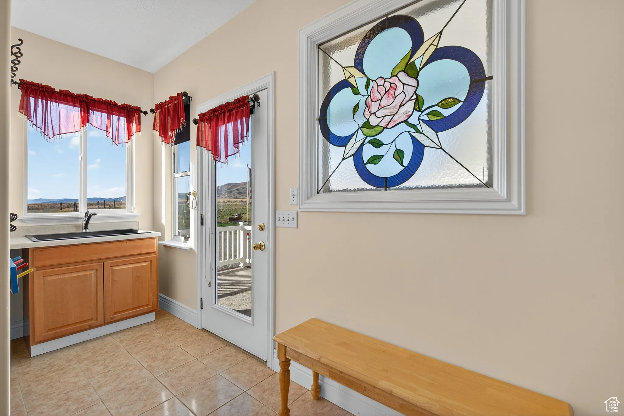 Doorway featuring tile patterned floors and a sink.