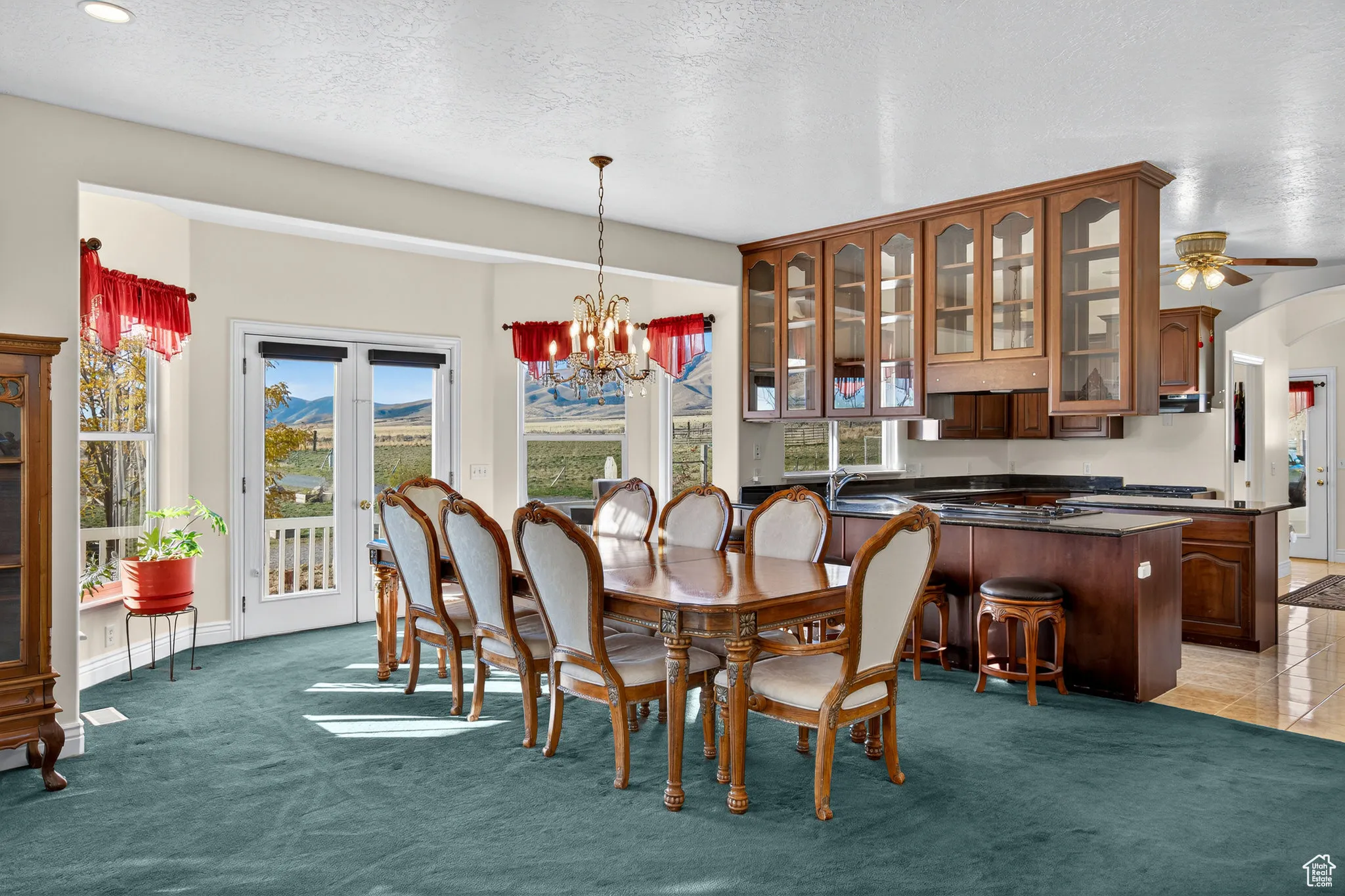 Dining area featuring a chandelier, French doors to porch.