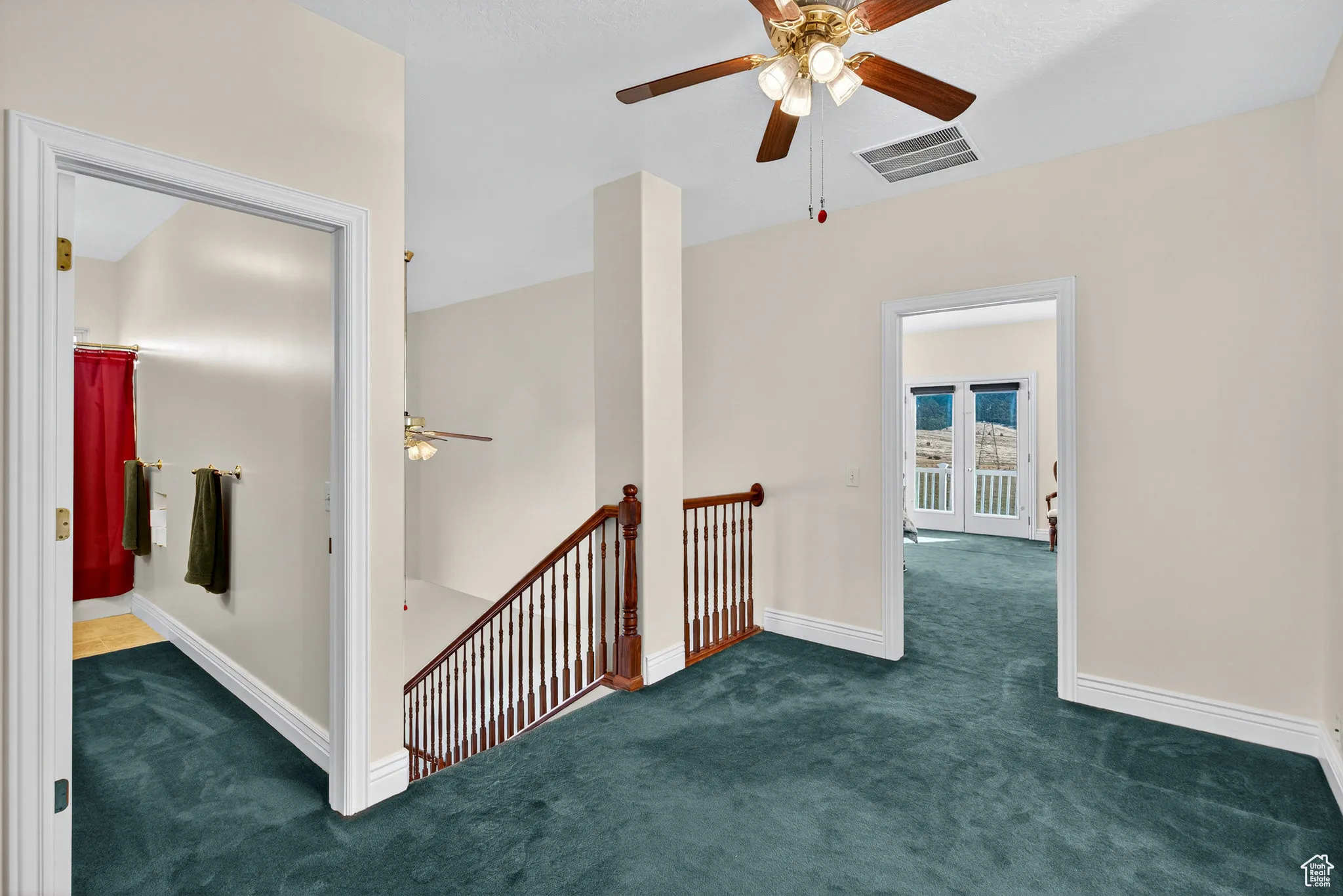Corridor featuring carpet and an upstairs landing.