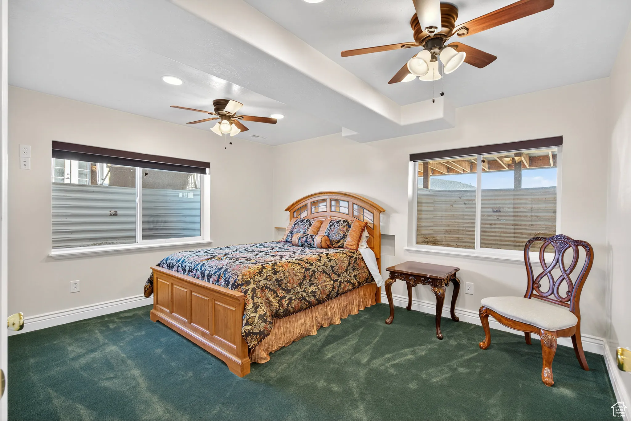 Basement bedroom featuring dark carpet, a ceiling fan, and recessed lighting.