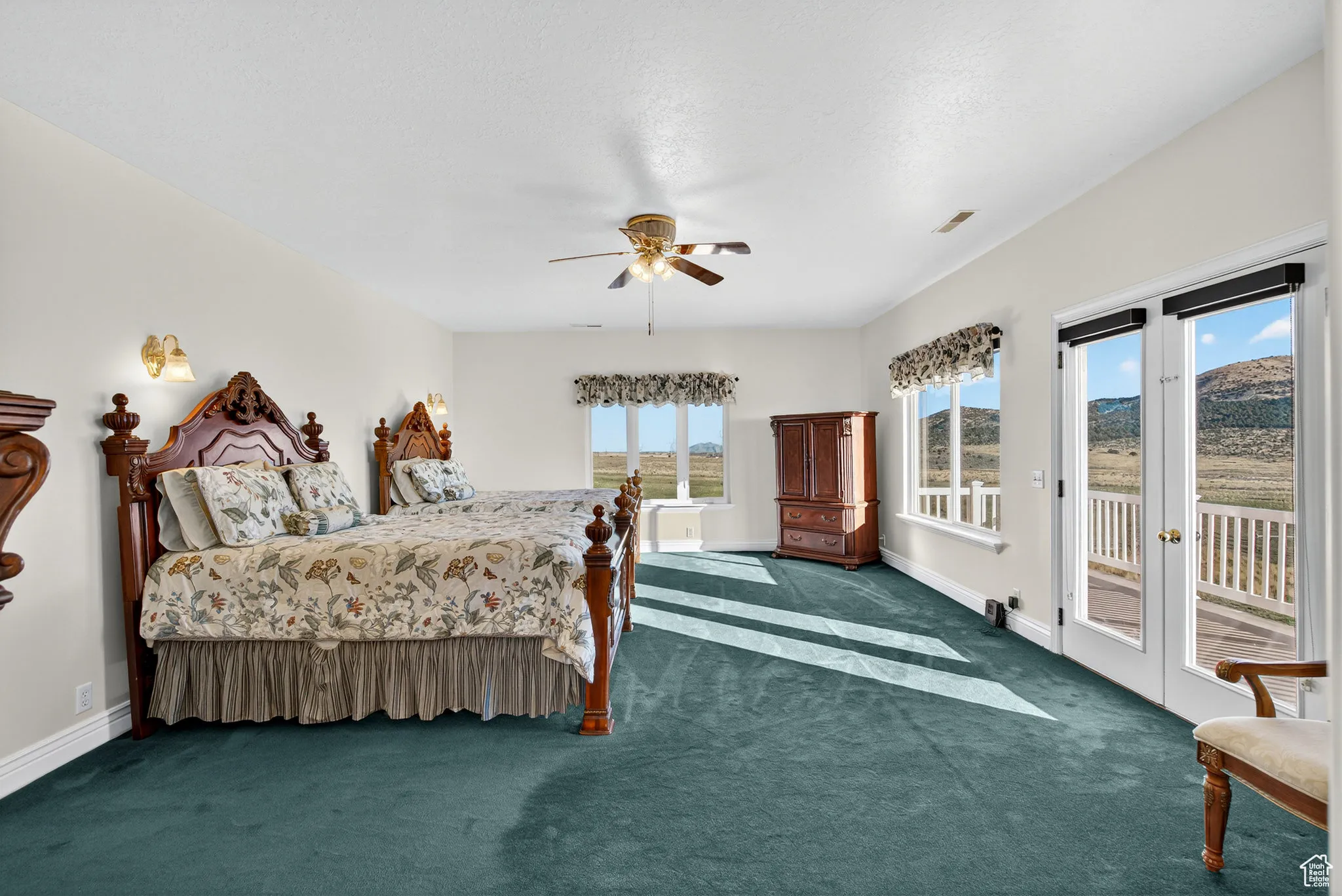 Bedroom featuring access to outside, carpet, french doors, and a ceiling fan.