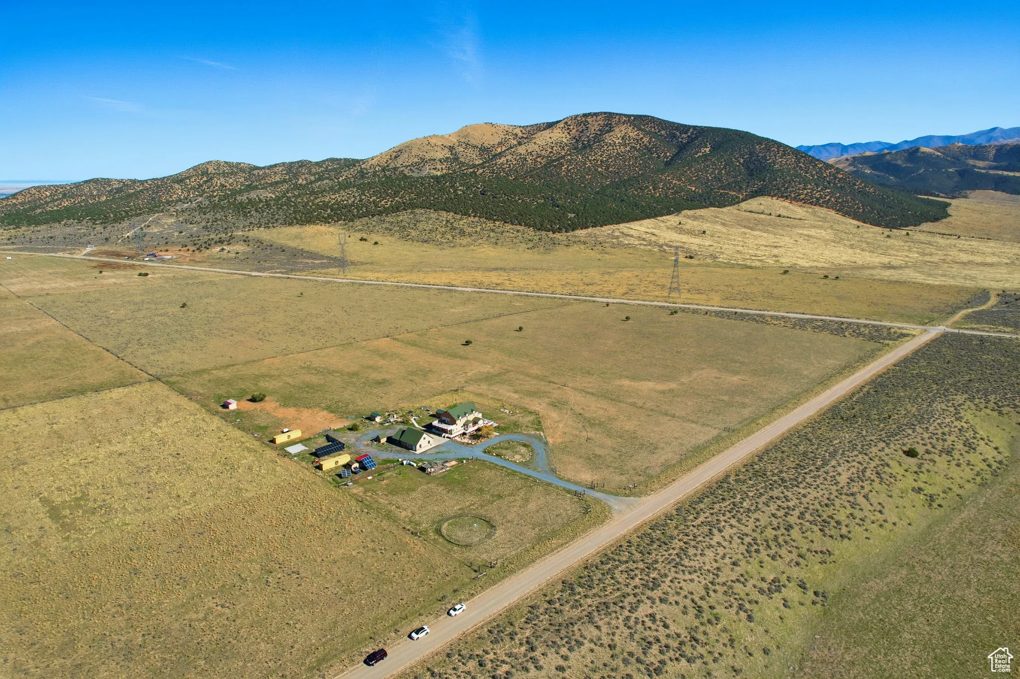 Aerial view of property's location featuring rural landscape, a mountainous background, north east.