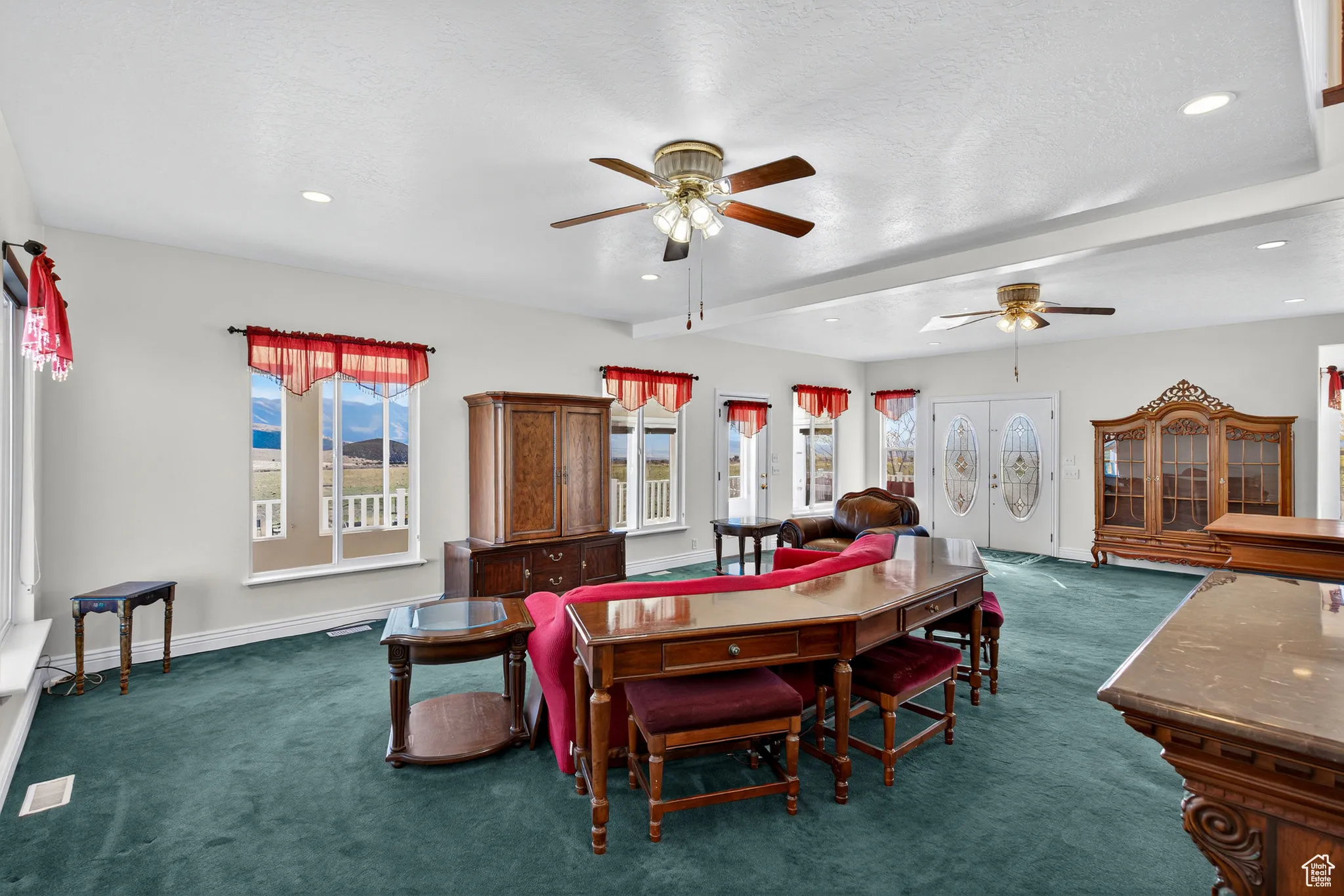 Dining space featuring carpet, beamed ceiling, recessed lighting, and a ceiling fan, door to sun room.
