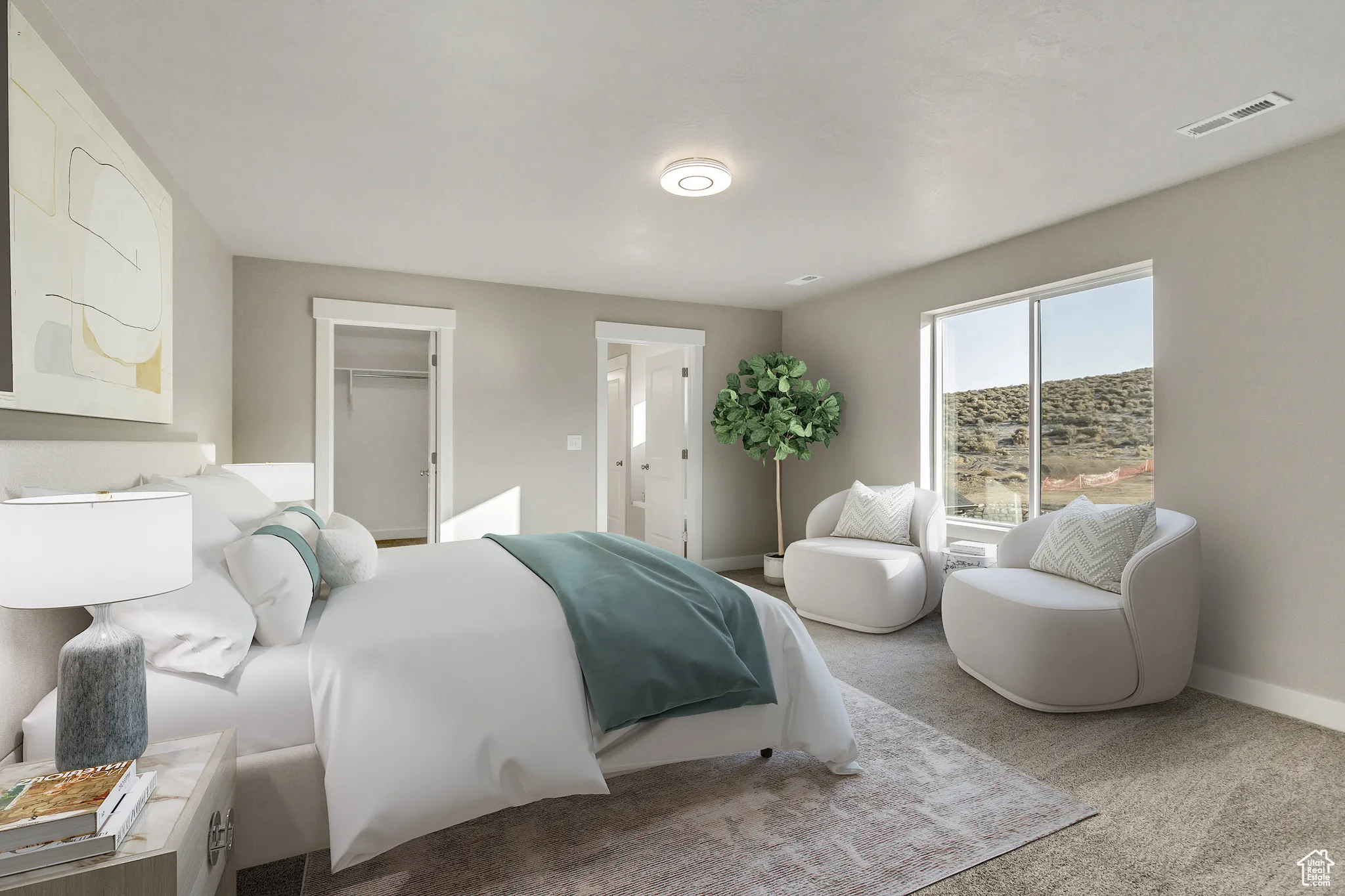 Bedroom featuring carpet and a spacious closet