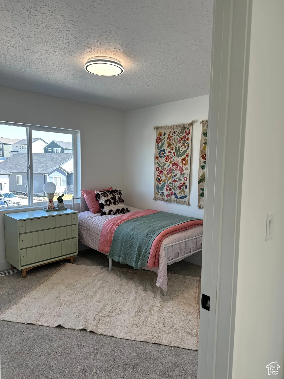Carpeted bedroom featuring a textured ceiling