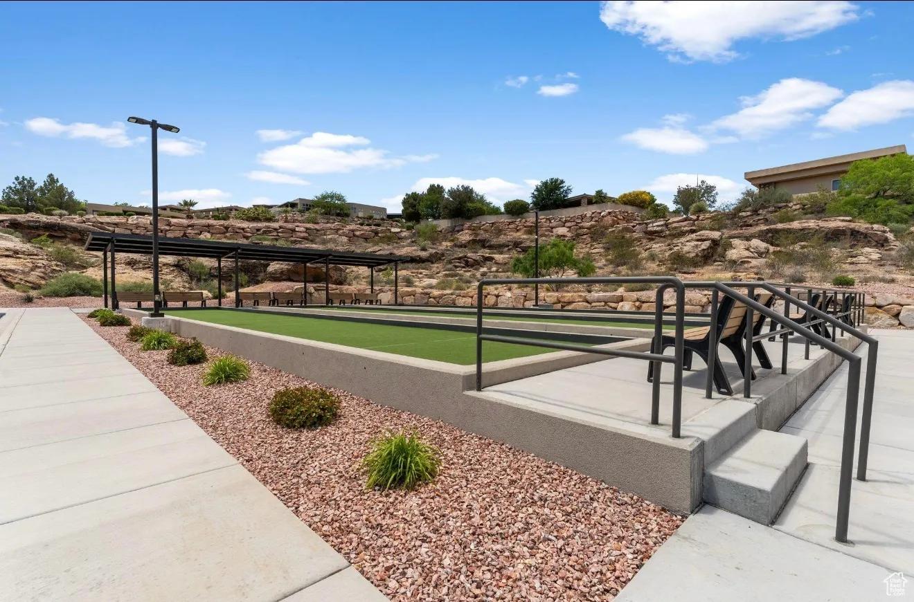 View of property's community with a bocce ball area and a patio