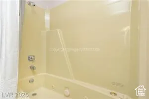 Full bathroom with shower / bath combo with shower curtain