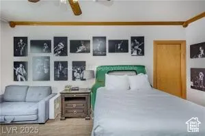 Bedroom featuring wood finished floors and a ceiling fan