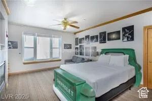 Bedroom with ornamental molding and a ceiling fan