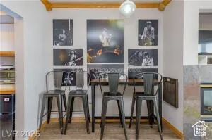 Bar featuring wood finished floors and black fridge