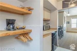 Kitchen featuring light countertops, pendant lighting, light carpet, and oven
