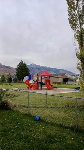 Community playground featuring a mountain view