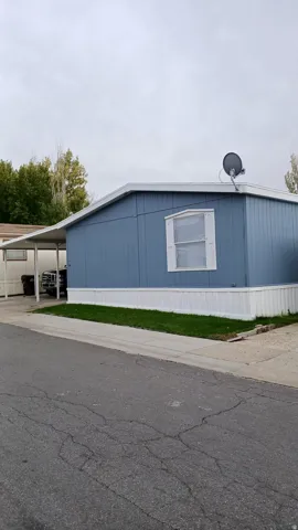 View of side of property with a carport