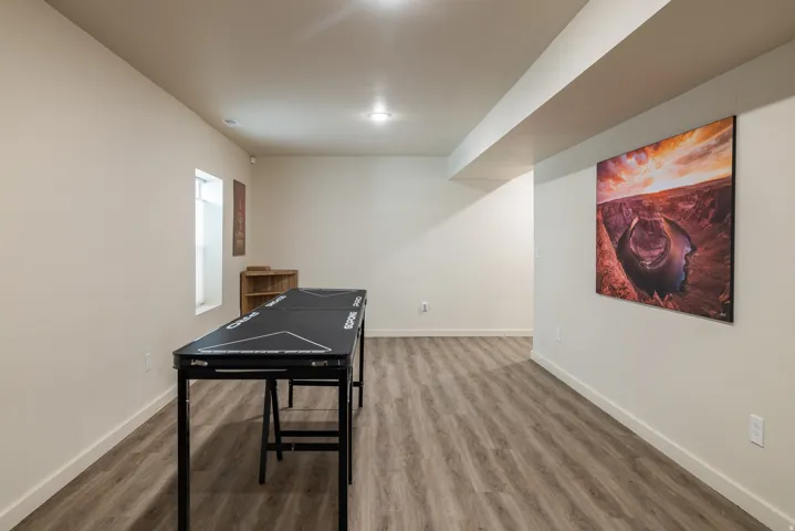 Recreation room featuring wood finished floors and baseboards