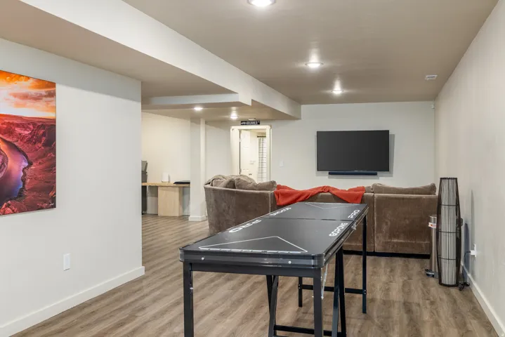 Playroom with light wood-style floors and recessed lighting