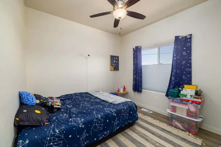 Bedroom featuring wood finished floors and ceiling fan