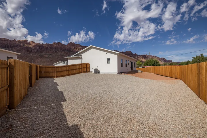 Fenced backyard with a mountain view