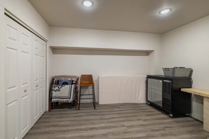 Living area with light wood-style flooring and recessed lighting