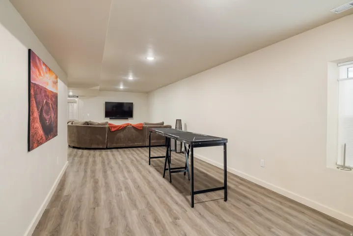 Living room with light wood-style floors and baseboards