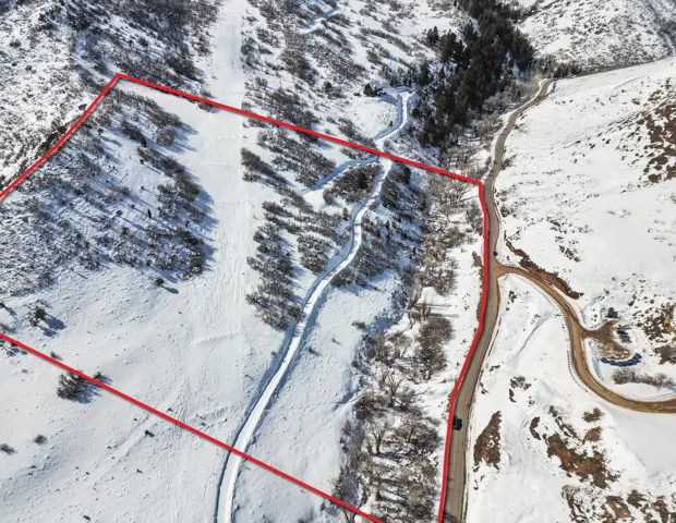 Snowy aerial view featuring property boundaries highlighted