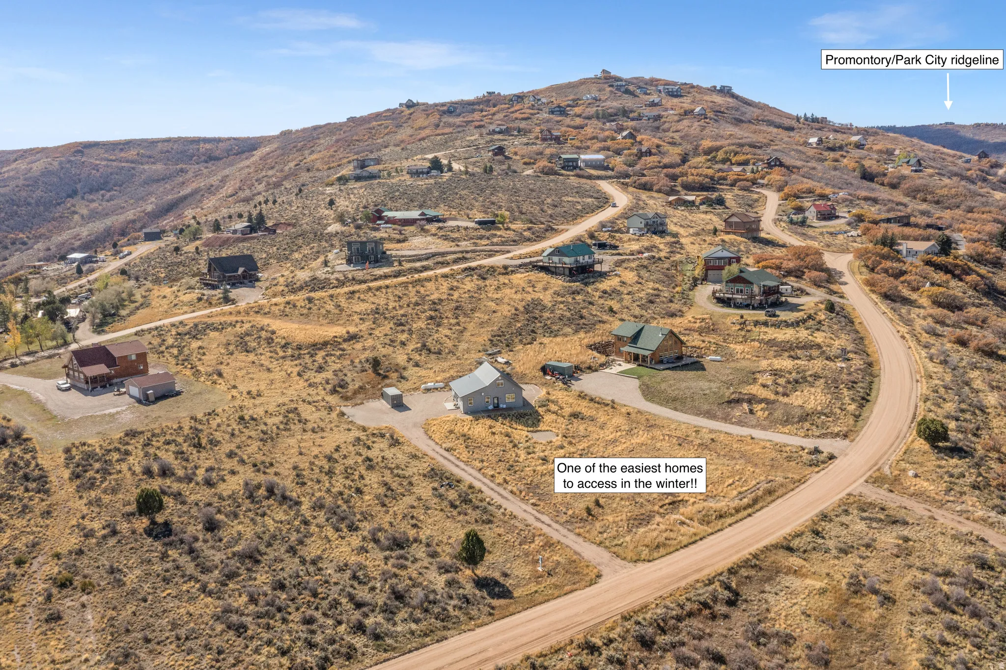 Aerial overview of property's location featuring a mountainous background and rural landscape