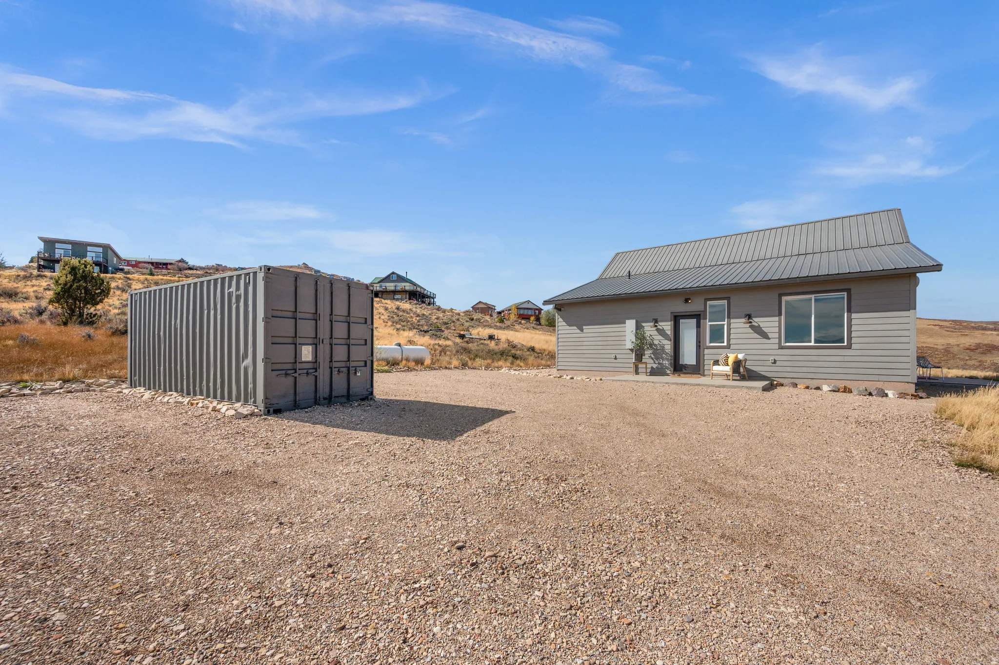 Back of house featuring a metal roof and a patio area