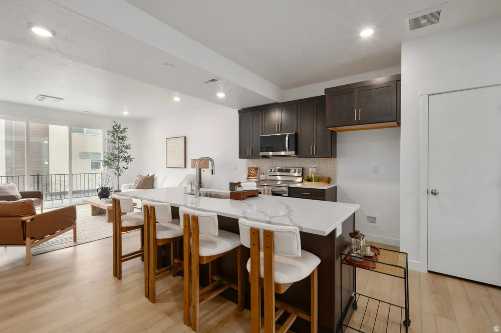 A total 'wow' kitchen-quartz countertops, stainless appliances, and a big island for charcuterie or homework. *Model