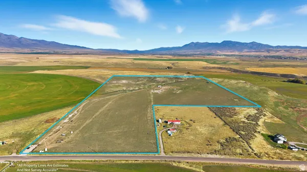 Aerial view of sparsely populated area featuring a mountain backdrop and property boundaries highlighted