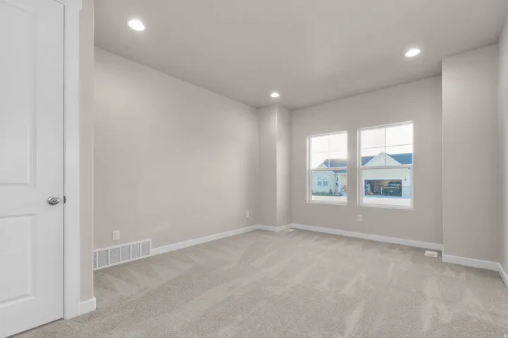 Unfurnished room featuring light carpet and recessed lighting