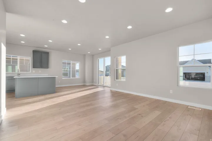 Unfurnished living room with recessed lighting, plenty of natural light, and light wood-style flooring