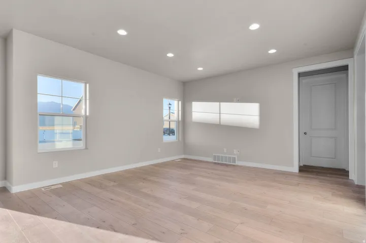 Empty room featuring recessed lighting and light wood-style floors