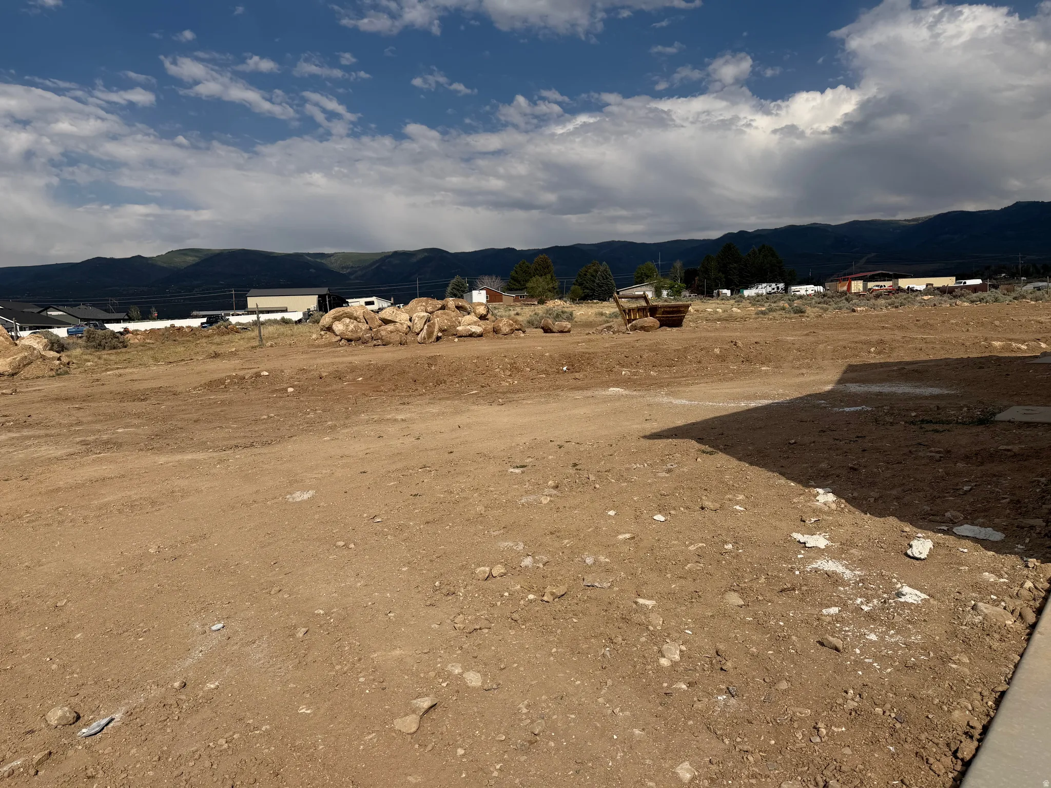 Cleared land parcel with a distant mountain range backdrop