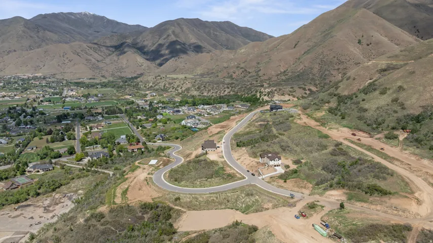 Newly developed cul-de-sac with paved roads and mountain backdrop
