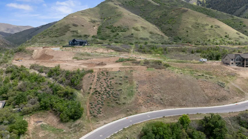 Expansive hillside property featuring graded building sites, established road infrastructure, and natural mountain landscaping
