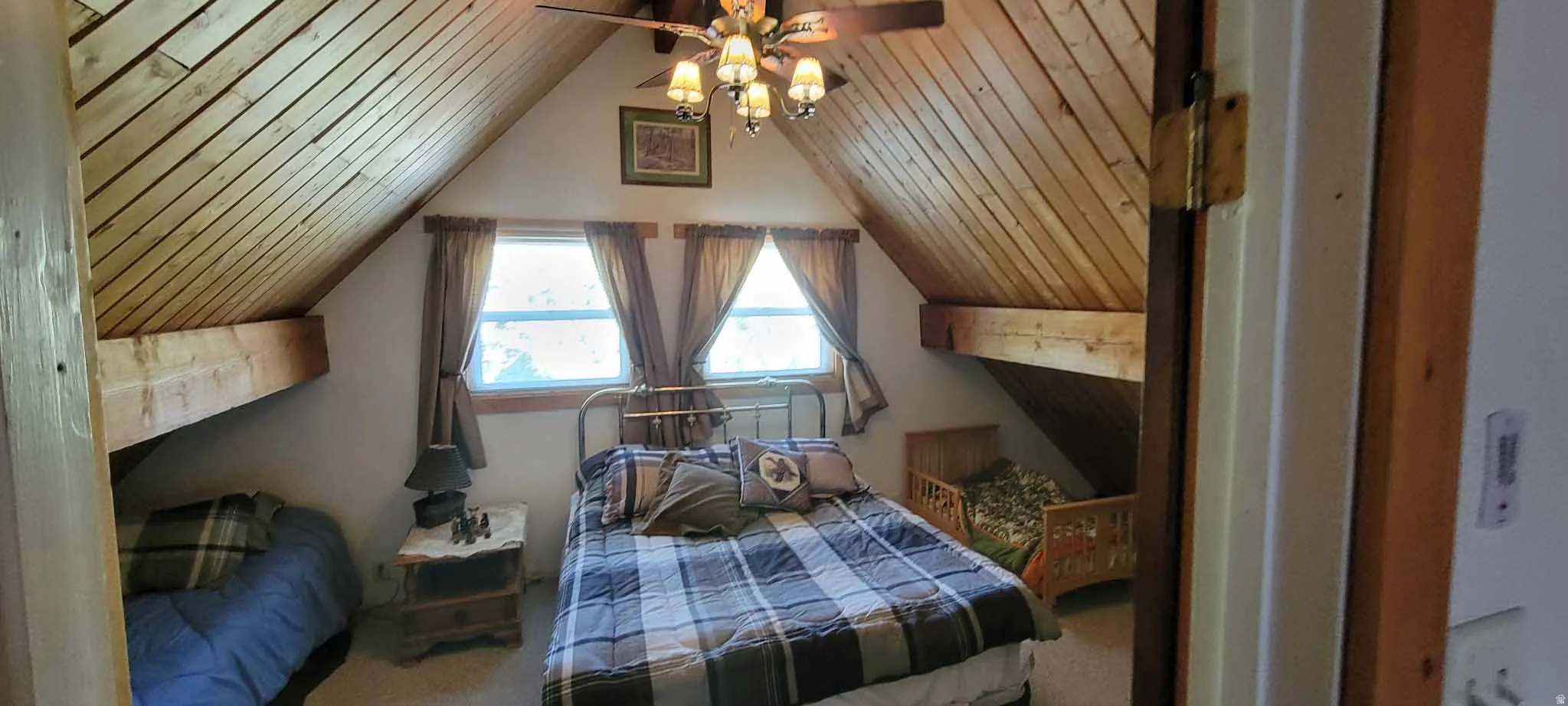 Bedroom with wooden ceiling, carpet flooring, vaulted ceiling, and ceiling fan