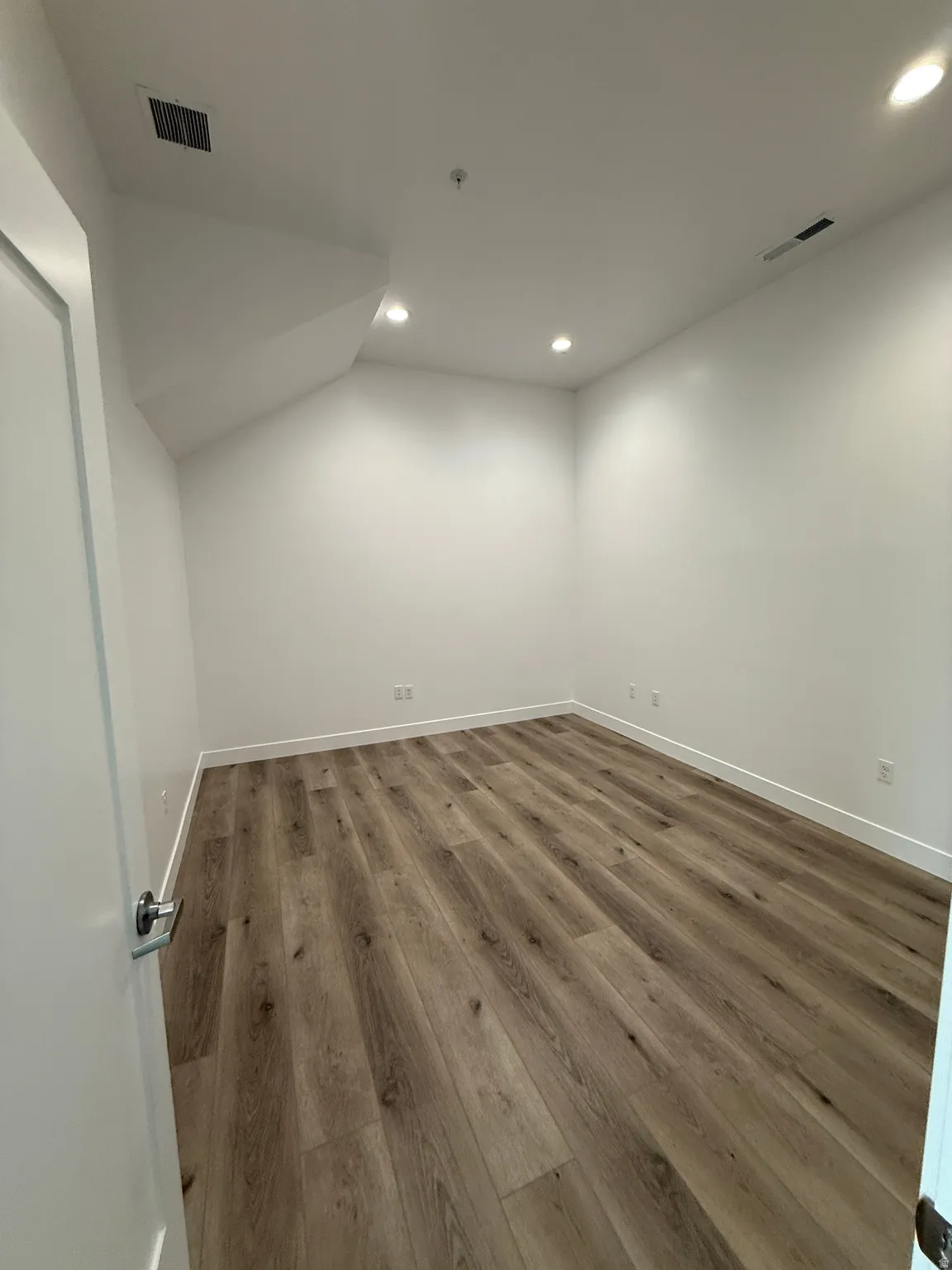Below grade area featuring recessed lighting and wood finished floors