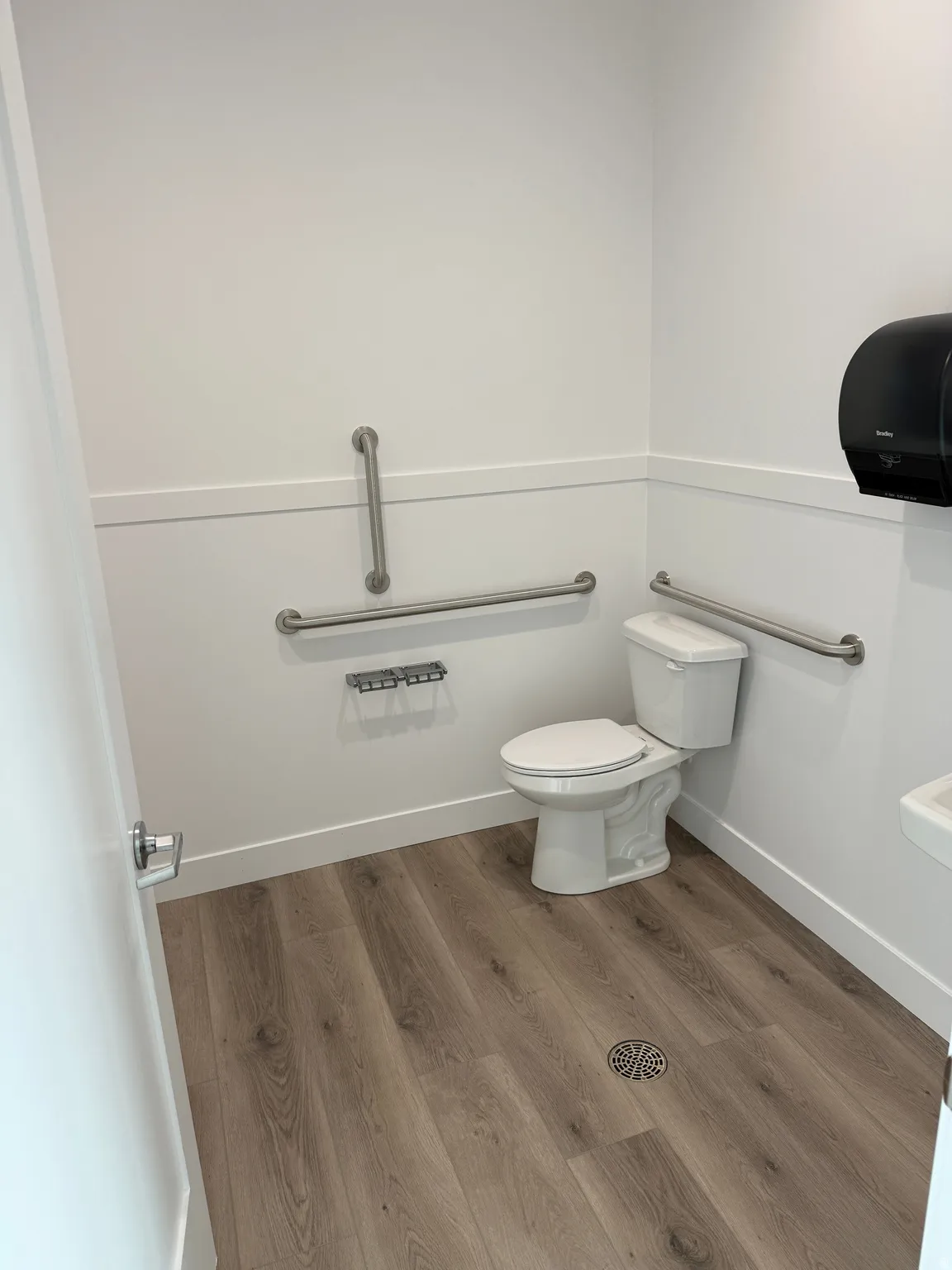 Bathroom featuring wood finished floors and toilet