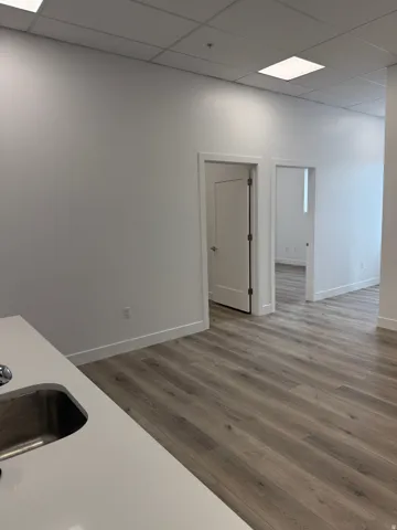 Bar featuring a paneled ceiling and light wood-style floors
