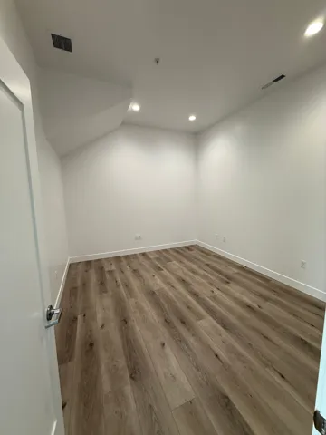 Below grade area featuring recessed lighting and wood finished floors