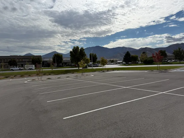 Uncovered parking lot featuring a mountain view