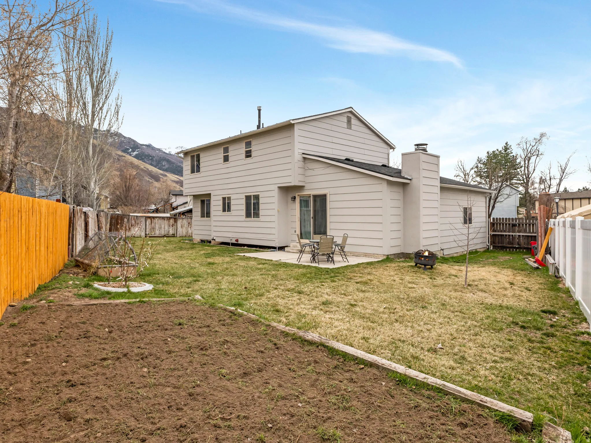 Back of property featuring a patio area, a fenced backyard, and a chimney