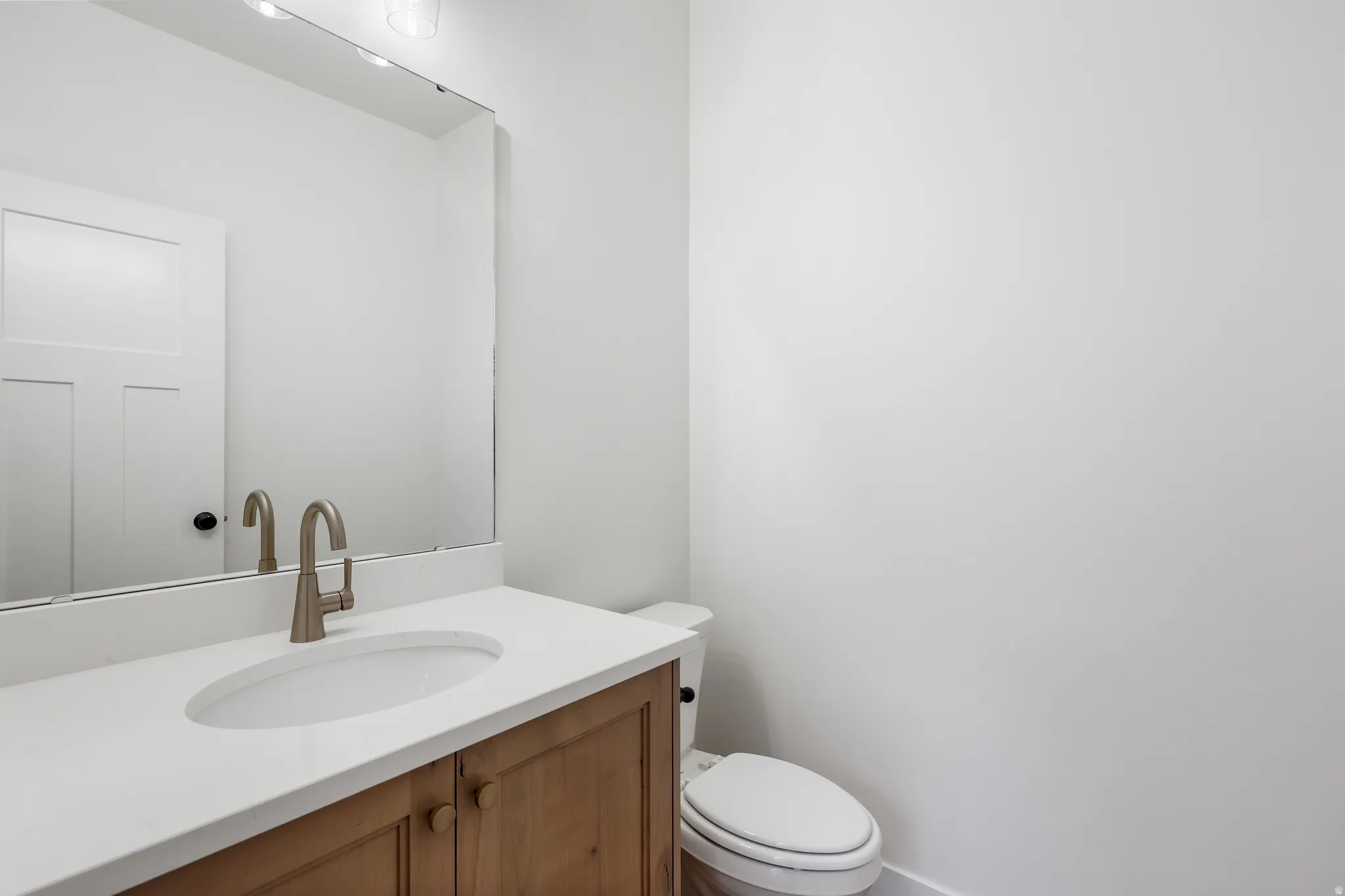 Half bath with vanity and toilet