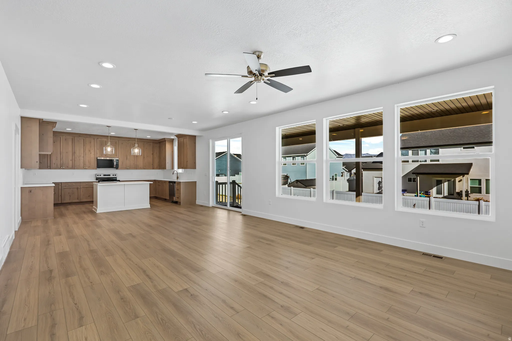Unfurnished living room featuring recessed lighting, light wood finished floors, and a ceiling fan