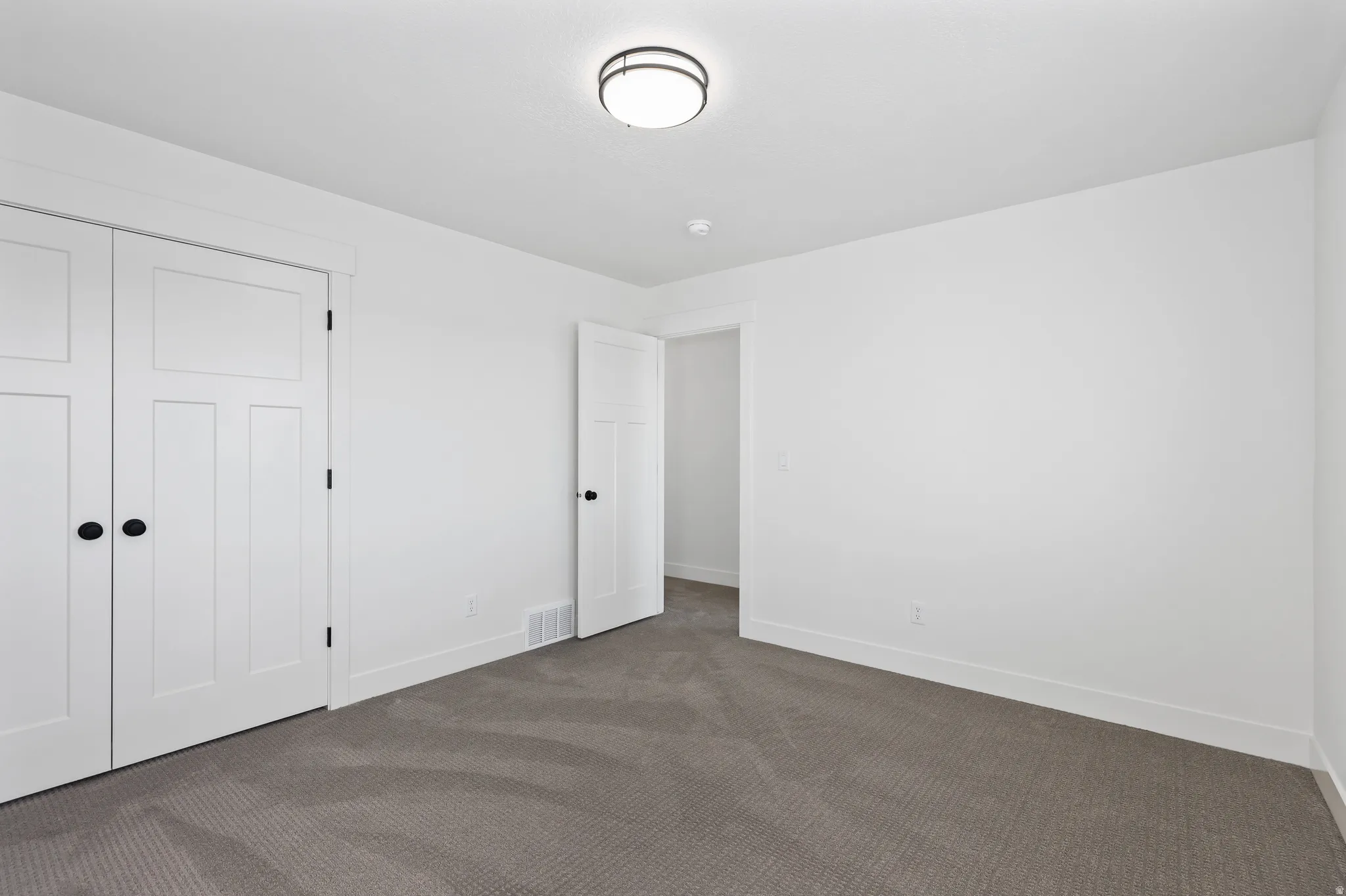 Unfurnished bedroom with carpet flooring and a closet