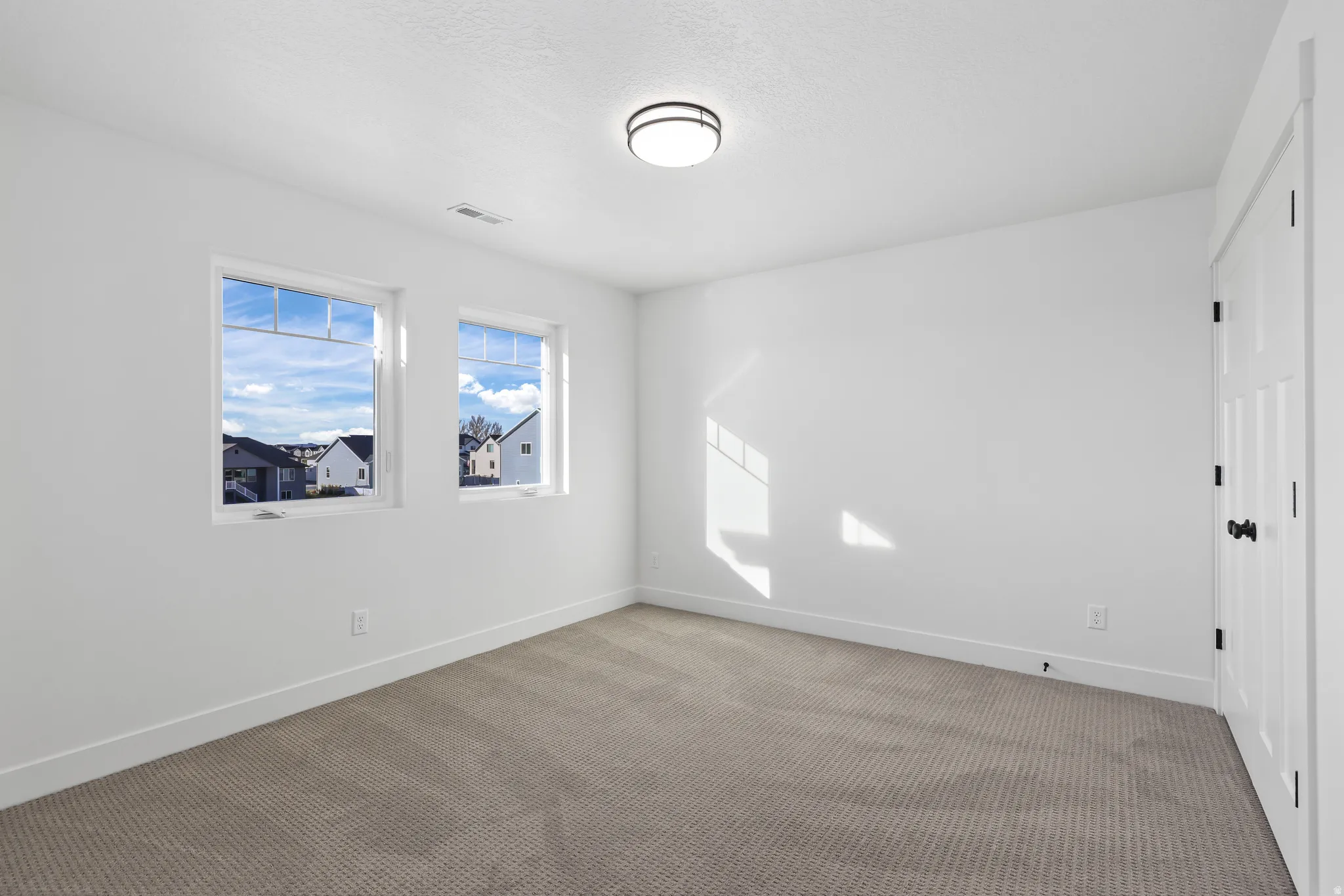 Unfurnished room with carpet flooring and baseboards