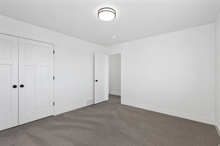 Unfurnished bedroom with carpet flooring and a closet