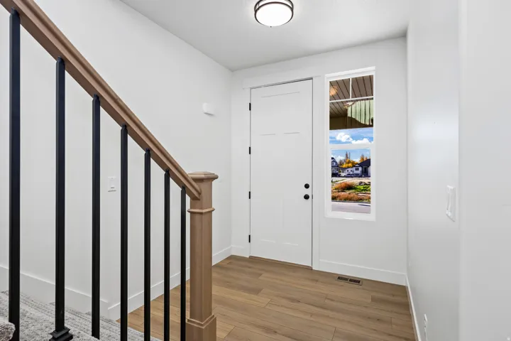 Foyer entrance featuring stairway and light wood-type flooring