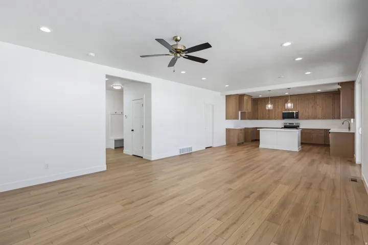 Unfurnished living room with recessed lighting, light wood-style flooring, and ceiling fan