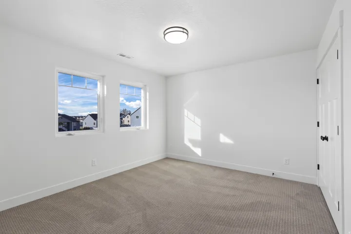Unfurnished room with carpet flooring and baseboards