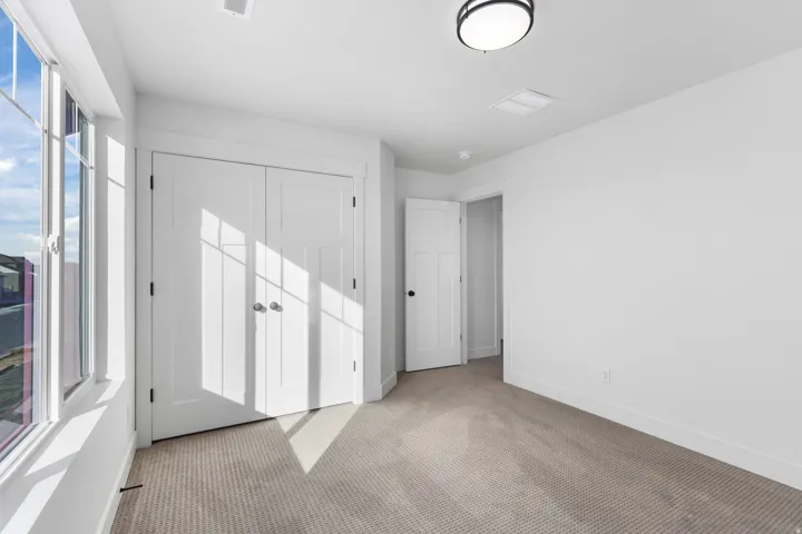 Unfurnished bedroom with carpet and a closet